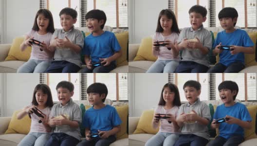 男孩和女孩在家里一起玩主机游戏。孩子们带着快乐的情绪玩游戏。高清在线视频素材下载