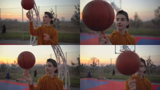 十几岁的男孩在操场上旋转篮球高清在线视频素材下载