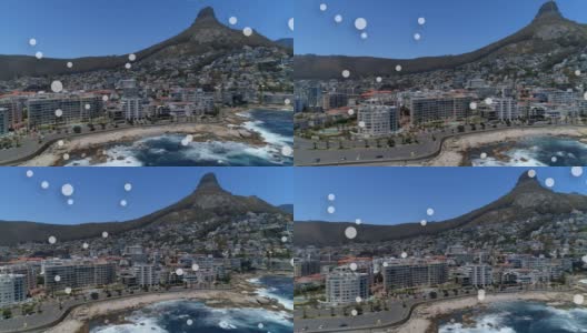 数字构图的多个白色斑点漂浮在鸟瞰图的城市景观高清在线视频素材下载