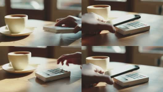 在咖啡店使用NFC技术用智能手机付款高清在线视频素材下载