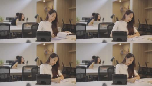 亚洲女性在办公室共享办公空间工作。高清在线视频素材下载