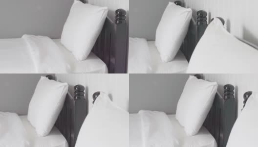白色的枕头和床在酒店的卧室内部高清在线视频素材下载