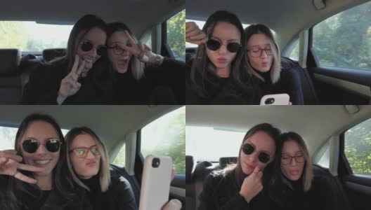 两个闺蜜在车后座用智能手机自拍。女孩微笑着摆姿势拍照高清在线视频素材下载