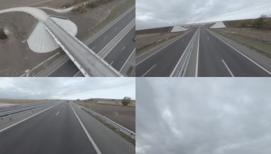 快速飞行高速公路fpv运动无人机在高速公路沥青路面上与驾驶汽车，汽车，卡车高清在线视频素材下载