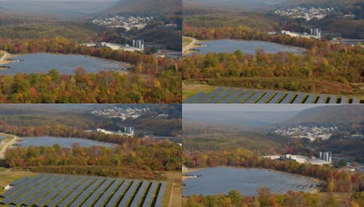 宾夕法尼亚州阿巴拉契亚山脉的大型太阳能农场，在一个多彩的秋天。空中视频与反向摄像机运动。高清在线视频素材下载