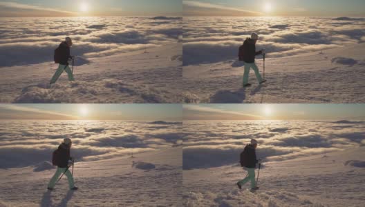 女孩徒步旅行在雪上的斯洛伐克山脉在冬季日落云层之上的慢动作高清在线视频素材下载