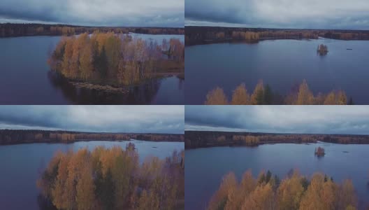 在秋天的森林中，在蓝色的湖上有一个黄色的树木繁茂的岛屿高清在线视频素材下载