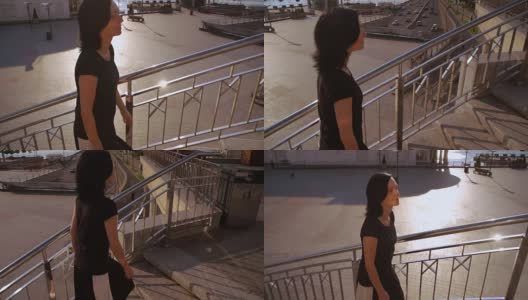 在令人惊叹的城市景观中爬楼梯的女人高清在线视频素材下载