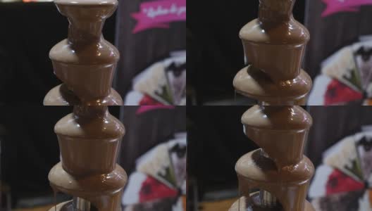 一段巧克力喷泉的镜头，画面从上往下移动高清在线视频素材下载