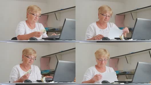 一位上了年纪的妇女拿出现金去付账单高清在线视频素材下载