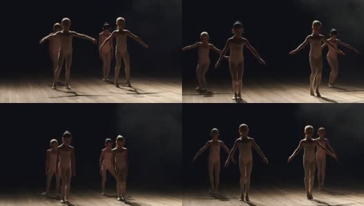 一群芭蕾舞者在黑暗中在舞台上跳舞高清在线视频素材下载