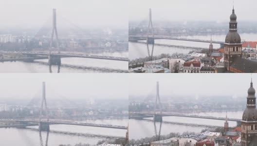 里加,拉脱维亚。俯视图的城市景观。薄雾多雨冬日里的万苏桥和里加圆顶大教堂高清在线视频素材下载