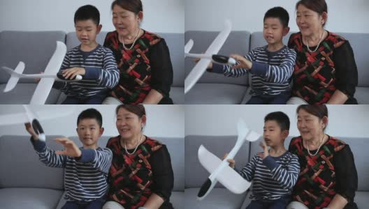 孙子向奶奶展示飞机模型高清在线视频素材下载