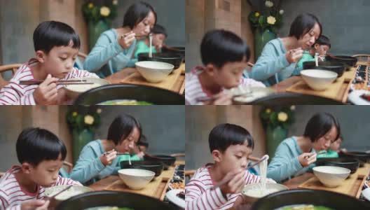 男孩用筷子吃米线高清在线视频素材下载