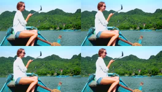 金发女人在划船经过山坡的时候自拍高清在线视频素材下载
