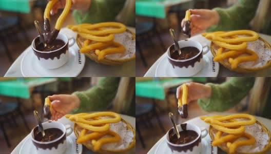 一个白人女人在西班牙咖啡馆吃油条和巧克力高清在线视频素材下载