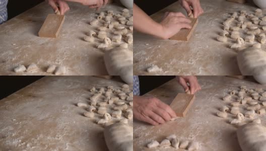 用全麦面粉制作自制素食意面的过程。家庭厨师在木砧板上擀面团，传统的意大利面食，女人在厨房做饭高清在线视频素材下载