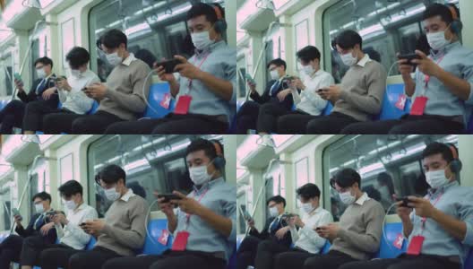 年轻男子在地铁安全行驶时使用手机保持社交距离高清在线视频素材下载