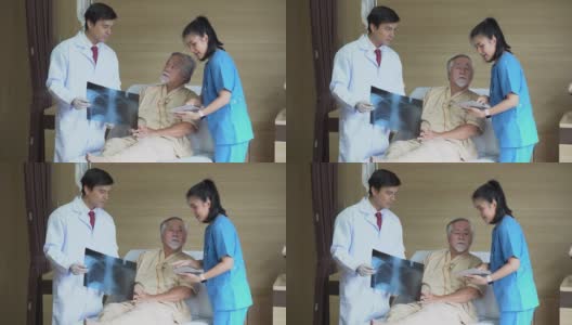 一位年轻的亚洲医生用x光片向病人解释治疗后的症状。一位外科医生在医院病床上用平板电脑与一位老人交谈。高清在线视频素材下载