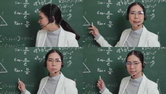 年轻的亚洲女教师手持粉笔，戴着耳机，与学生看着摄像机进行视频会议。女教师在课堂上培训数学黑板在线课程。高清在线视频素材下载
