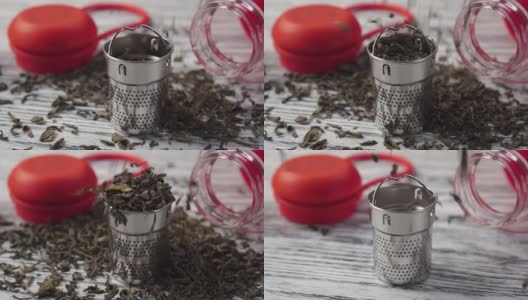 干绿茶。中国茶具，一个过滤器和一个红色塑料玻璃茶壶特写高清在线视频素材下载