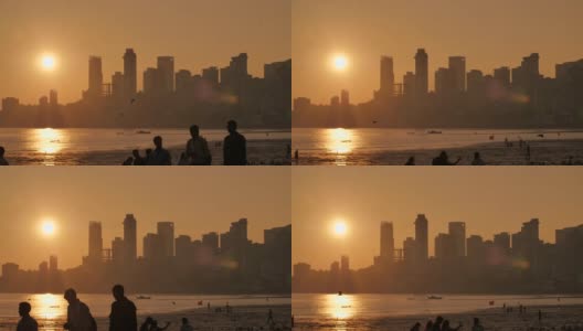 夕阳映衬在孟买的摩天大楼上。乔佩蒂海滩的景色高清在线视频素材下载