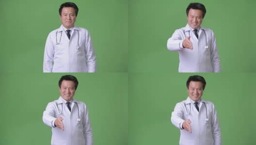 成熟的日本男人医生反对绿色背景高清在线视频素材下载
