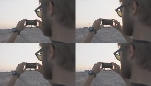 模特在海滩发布了智能手机摄影师高清在线视频素材下载