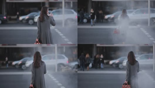 一名妇女在人行横道处过马路高清在线视频素材下载