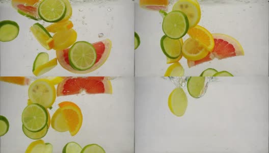 几片柠檬、柠檬、橙子、葡萄柚等柑橘类水果落入水中，溅起水花和气泡，这是慢镜头特写高清在线视频素材下载