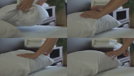 五星级酒店的服务员整理床铺和调整枕头，完美的服务高清在线视频素材下载