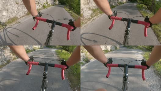 镜头:骑着自行车在空旷的柏油路上飞驰，穿过森林高清在线视频素材下载