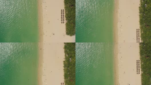 阳光明媚的三亚著名的大东海拥挤的海滩空中全景4k海南中国高清在线视频素材下载