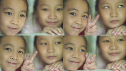 两个亚洲小女孩做的和平手势高清在线视频素材下载
