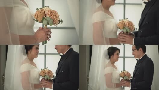 新郎和新娘在婚纱室拍婚纱照。手持拍摄，真实生活高清在线视频素材下载