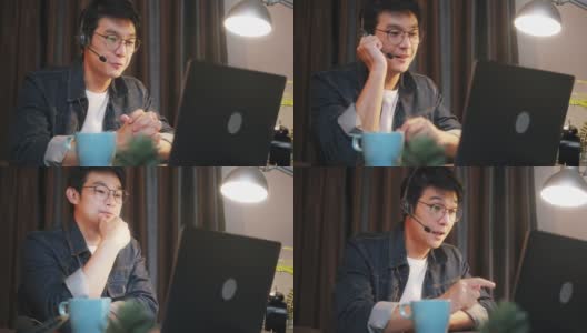 一名亚洲男子在家中使用笔记本电脑进行视频电话会议，工作到很晚高清在线视频素材下载