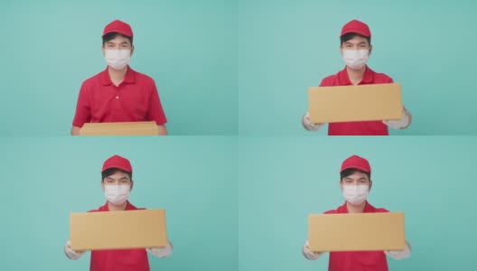 孤立背景，身穿红色制服的亚洲快递员戴着面具，手里拿着一个中等大小的包裹，在前面让步。男邮差竖起大拇指，面带微笑。交付的概念高清在线视频素材下载