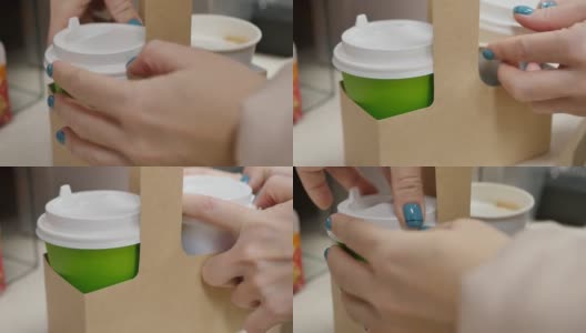 涂着绿色指甲的女人的手盖上了装卡布奇诺的纸杯高清在线视频素材下载