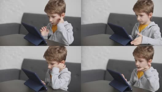 可爱的小男孩用垫子。孩子在家里玩数码平板电脑。孩子们的自由时间、科技和互联网高清在线视频素材下载