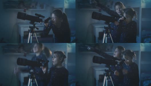 在夜晚拍摄的电影中，穿着缀满星星的睡衣的两个快乐的小女孩正在通过望远镜观看黑暗的天空中坠落的星星。概念:探索、教育、童年高清在线视频素材下载