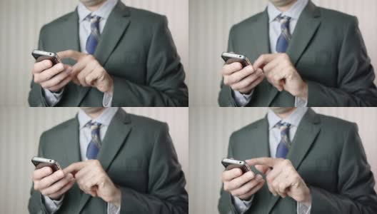 手持智能手机iPhone的商人高清在线视频素材下载