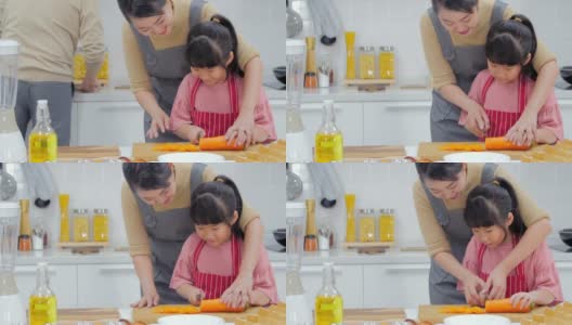一个快乐的年轻家庭，妈妈，爸爸和小女孩在厨房里一起做饭高清在线视频素材下载