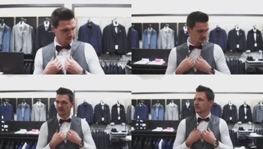 他正在一家时髦优雅的商店里为他的婚礼挑选合适的衣服高清在线视频素材下载