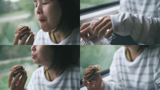 女人在火车上吃纸杯蛋糕高清在线视频素材下载