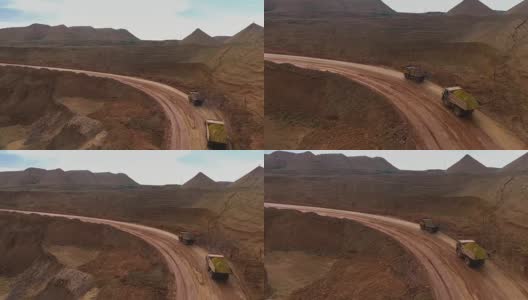 两辆自动倾卸卡车将矿石从采石场运出。矿井全景图。新月形沙丘砂。矿产资源的开发。高清在线视频素材下载