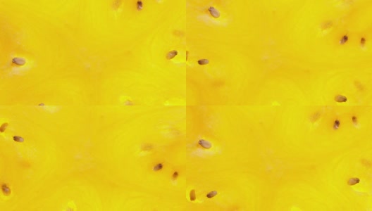 令人惊叹的俯视图，整个一片黄色的西瓜，旋转的白色背景与背光顺时针靠近。高清在线视频素材下载