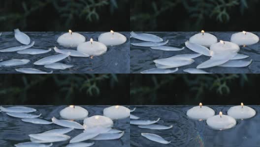 小蜡烛燃烧和荷花花瓣落入水中的特写高清在线视频素材下载
