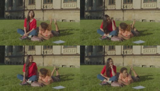 可爱的女学生在校园草坪上休息高清在线视频素材下载