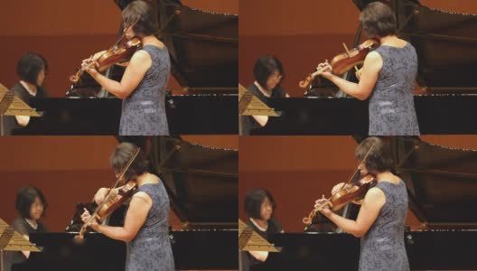 在古典音乐会上演奏的钢琴家和小提琴家高清在线视频素材下载
