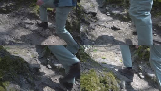 让徒步旅行者走在森林的小上坡路-鞋的特写高清在线视频素材下载